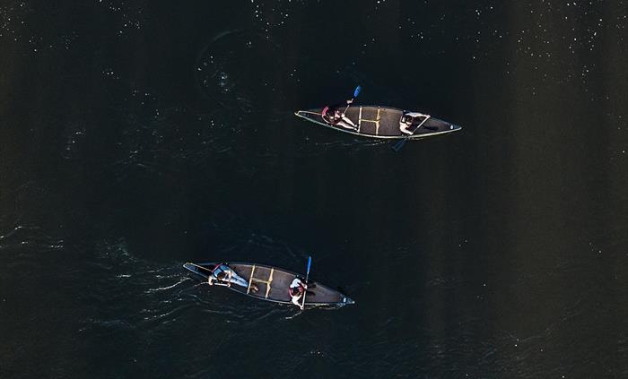 Two canoeists paddling the River Wye, photo taken from above.
